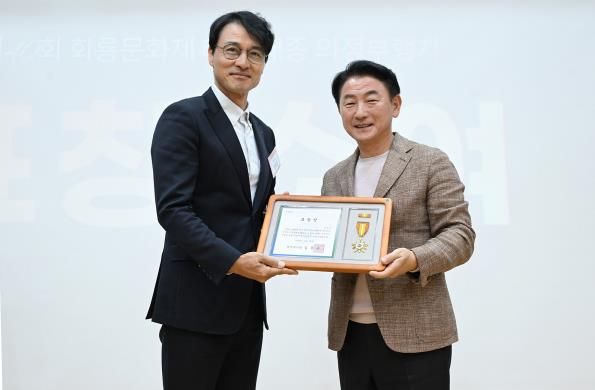 김동근 시장이 10월 28일 ‘제40회 회룡문화제 성과공유회’에서 ‘태조‧태종 의정부행차’에 참여했던 배우 정의갑 씨에게 표창장을 수여한 뒤 함께 기념사진을 찍고 있다.